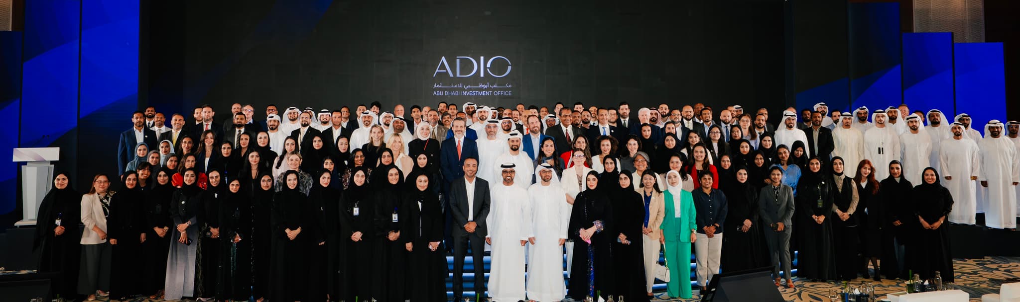 The ADIO team on stage beneath the ADIO wordmark
