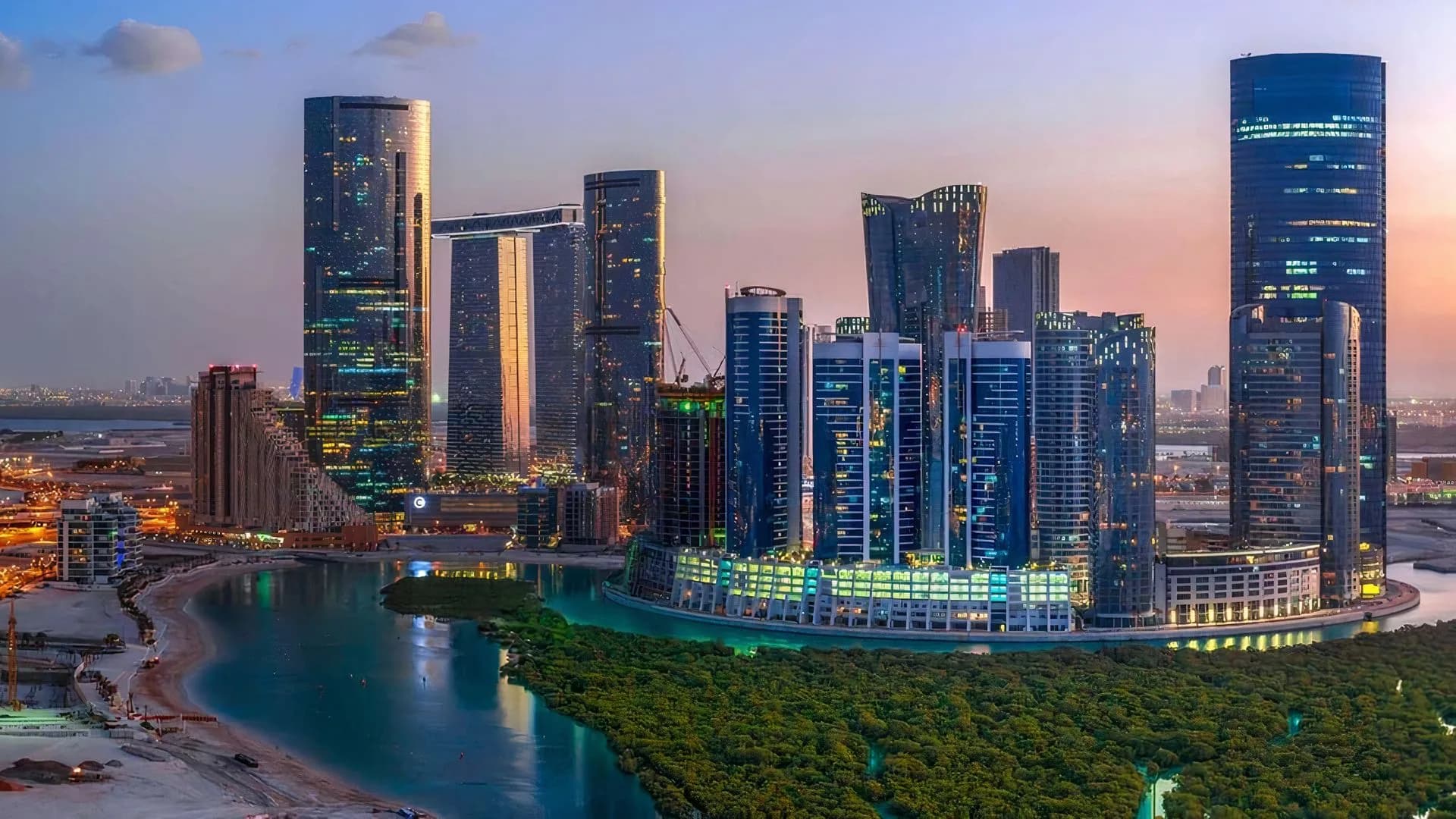 Abu Dhabi's industrial skyline and waterfront at dusk